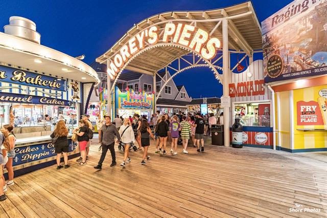 People enjoying a lively evening at Morey's Piers amusement park.